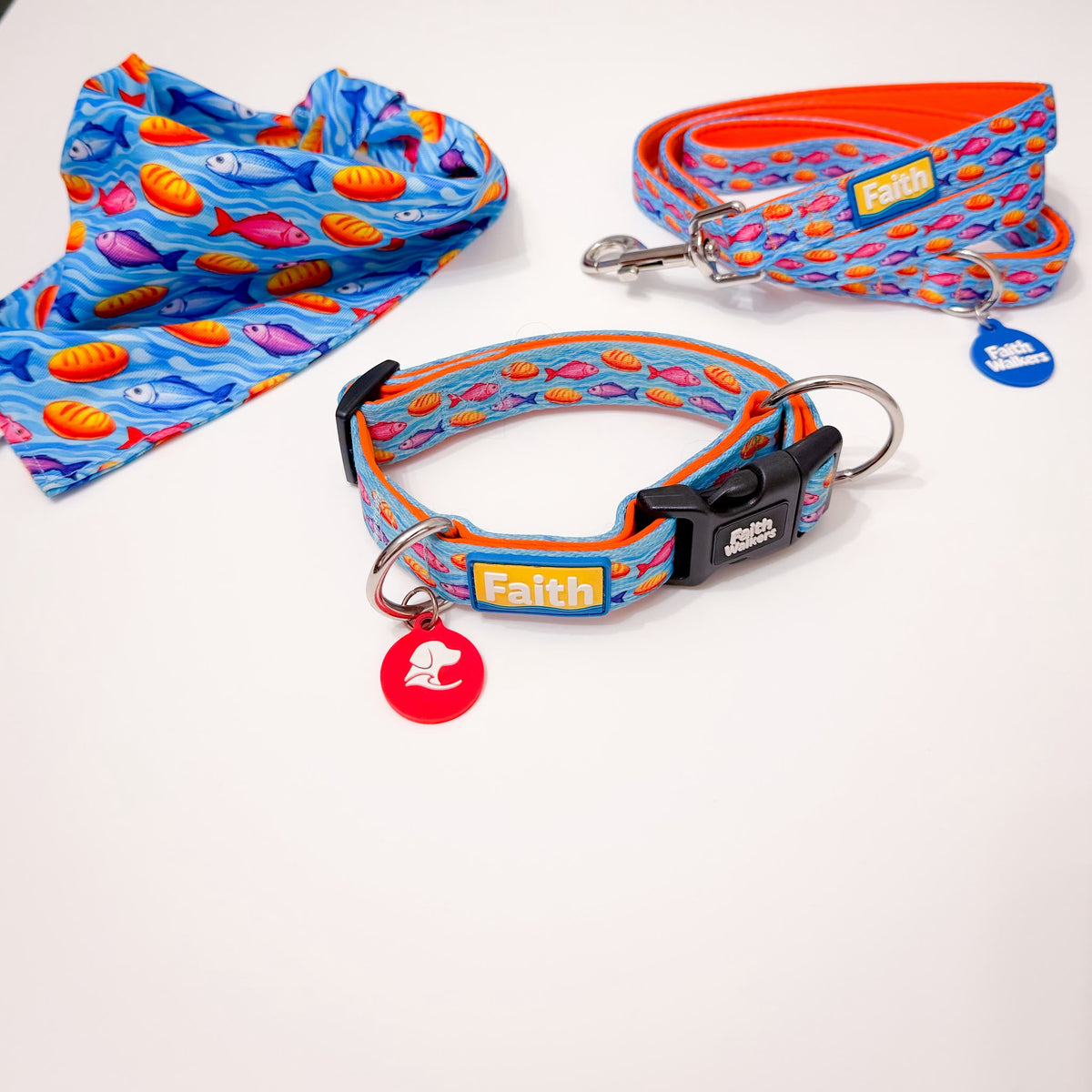 Loaves and Fishes dog collar, leash and bandana with colorful fish and bread patterns on a blue background.