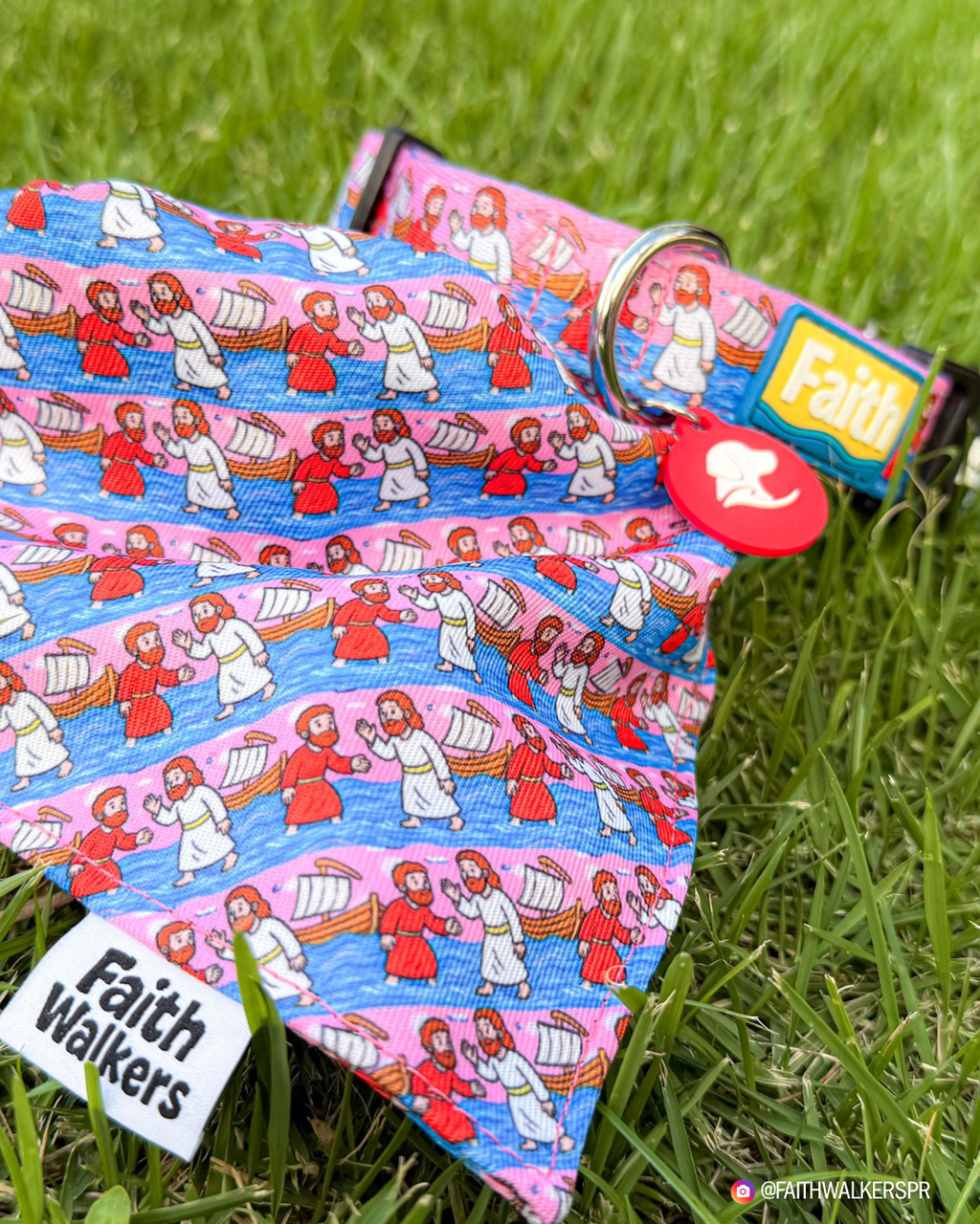 Walk by Faith patterned bandana and pink collar with a yellow Faith patch and red silent tag displayed on grass.
